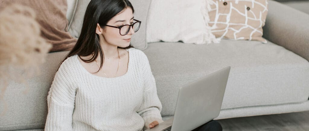 Woman at home watching on-demand event session recordings.