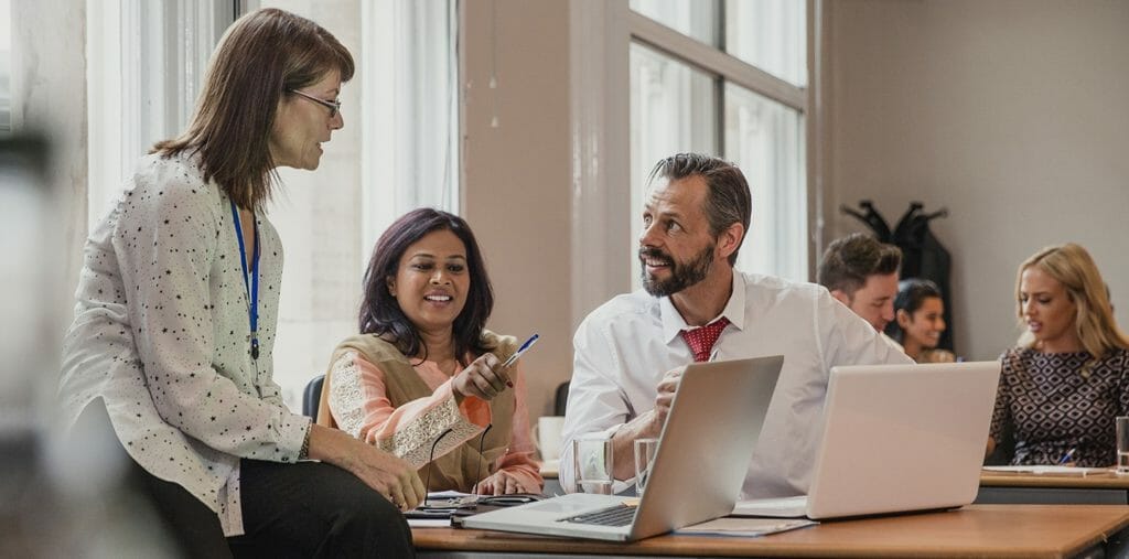 People looking at a computer in discussion