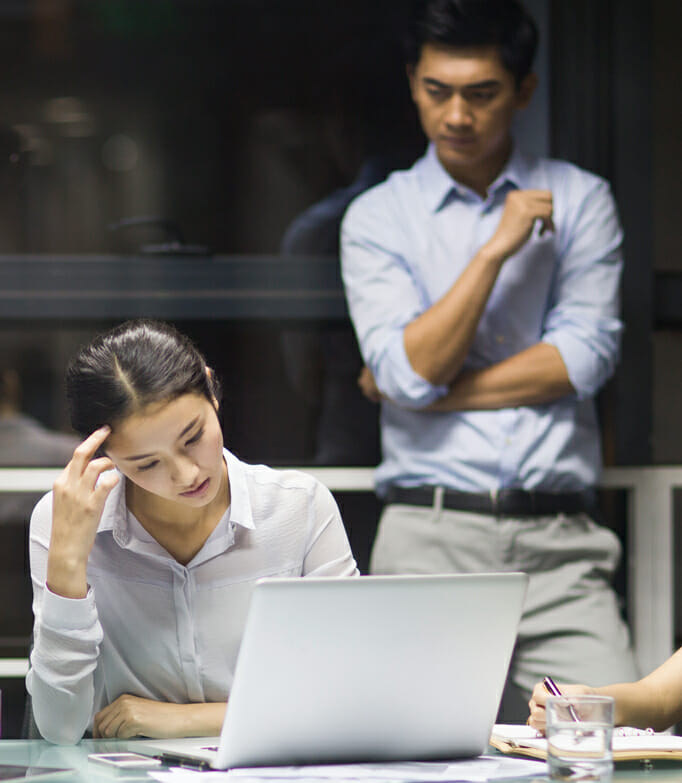 Image: 2 people looking at computer screen